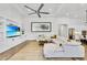 Open-concept living room with a large white sectional sofa, built-in shelving, and modern decor at 3379 Chestertown Loop, Bradenton, FL 34211