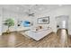Spacious living room featuring a custom built-in unit, ceiling fan, and wood-look tile flooring at 3379 Chestertown Loop, Bradenton, FL 34211