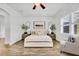 Serene bedroom with wood-look floors, large windows, and modern decor creating a peaceful retreat at 3379 Chestertown Loop, Bradenton, FL 34211