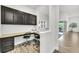 Bright office space with custom cabinets, granite counters, and wood-look tile flooring provides organized work space at 3379 Chestertown Loop, Bradenton, FL 34211