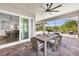 Covered patio boasts a dining area with views of a pool and well-manicured landscaping at 3379 Chestertown Loop, Bradenton, FL 34211