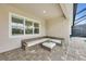 Cozy covered patio with comfortable seating, beautiful stone pavers, and a serene outdoor ambiance at 3379 Chestertown Loop, Bradenton, FL 34211