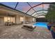 Outdoor pool area with a covered patio, lounge seating, ideal for enjoying the evening ambiance at 3379 Chestertown Loop, Bradenton, FL 34211