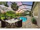 Outdoor living space showcasing a screened-in pool, sun loungers, and a dining area for upscale entertaining at 3379 Chestertown Loop, Bradenton, FL 34211