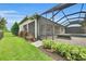 Landscaped backyard featuring a screened-in lanai and pool at 3379 Chestertown Loop, Bradenton, FL 34211