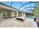 Outdoor pool area with a covered patio, dining and lounge seating, perfect for relaxation and entertainment at 3379 Chestertown Loop, Bradenton, FL 34211