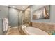 This bathroom contains a relaxing soaking tub, walk-in shower, and beach themed decor at 3430 77Th W St # 301, Bradenton, FL 34209