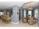 Inviting dining area with elegant chandelier, seating and adjacent breakfast bar and kitchen with stainless appliances at 3430 77Th W St # 301, Bradenton, FL 34209