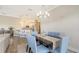 Open dining room area with table set for six and views of the modern kitchen at 3430 77Th W St # 301, Bradenton, FL 34209