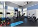 Well-equipped gym featuring modern exercise machines, weights, and a TV for a complete fitness experience at 3430 77Th W St # 301, Bradenton, FL 34209