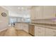 Bright kitchen features white cabinets, granite countertops, stainless steel appliances, and open dining area at 3430 77Th W St # 301, Bradenton, FL 34209