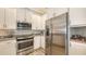 Well-equipped kitchen with stainless steel appliances, granite countertops, and stylish backsplash at 3430 77Th W St # 301, Bradenton, FL 34209