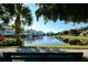 Scenic view of the pond with a fountain, palm trees, and well-maintained landscaping, creating a tranquil atmosphere at 3430 77Th W St # 301, Bradenton, FL 34209