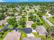 Aerial view of Wilkinson Woods featuring mature trees, lush landscaping and private ponds throughout the community at 3530 Wilkinson Woods Dr # 14, Sarasota, FL 34231