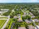 This house features a well-maintained roof, landscaping, a pond, and a private driveway within a lush, green community at 3530 Wilkinson Woods Dr # 14, Sarasota, FL 34231