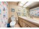 The bathroom features a single sink vanity, a toilet, a framed mirror and a tiled shower with bathtub at 3530 Wilkinson Woods Dr # 14, Sarasota, FL 34231