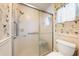Bathroom featuring a glass-door shower and a toilet at 3530 Wilkinson Woods Dr # 14, Sarasota, FL 34231