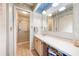 Well-lit bathroom with blue and white accents, featuring a vanity and tiled shower at 3530 Wilkinson Woods Dr # 14, Sarasota, FL 34231