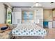 Bedroom with built-in shelving and a sofa for seating; bright and airy at 3530 Wilkinson Woods Dr # 14, Sarasota, FL 34231