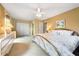 Spacious bedroom with a metal frame bed, plush carpet, and large window at 3530 Wilkinson Woods Dr # 14, Sarasota, FL 34231