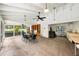 Open clubhouse with a table, chairs, and bright, open windows for lots of light and a view of the community pool at 3530 Wilkinson Woods Dr # 14, Sarasota, FL 34231