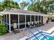 Spacious clubhouse with floor to ceiling windows overlooking the pool and a variety of seating for a relaxing atmosphere at 3530 Wilkinson Woods Dr # 14, Sarasota, FL 34231