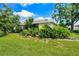 Well-manicured front lawn with colorful landscaping, adding curb appeal to this charming home at 3530 Wilkinson Woods Dr # 14, Sarasota, FL 34231