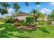 Landscaped front yard featuring lush tropical plants and shrubs creating a welcoming entrance to the home at 3530 Wilkinson Woods Dr # 14, Sarasota, FL 34231