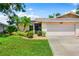 Charming single-story home featuring a well-manicured lawn and tropical landscaping with lovely curb appeal at 3530 Wilkinson Woods Dr # 14, Sarasota, FL 34231