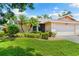 Charming single-story home featuring a well-manicured lawn and tropical landscaping with lovely curb appeal at 3530 Wilkinson Woods Dr # 14, Sarasota, FL 34231
