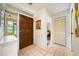 Hallway features decorative wallpaper, tile floors, and a view of the outdoor scenery through the front door glass at 3530 Wilkinson Woods Dr # 14, Sarasota, FL 34231