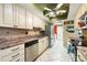 Kitchen features stainless steel appliances, light cabinetry, and neutral backsplash at 3530 Wilkinson Woods Dr # 14, Sarasota, FL 34231