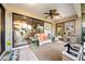 Enclosed lanai with comfortable seating, ceiling fan, tiled floors and view of lush yard at 3530 Wilkinson Woods Dr # 14, Sarasota, FL 34231