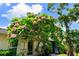 Beautiful landscaping with a mature flowering tree enhancing the home's curb appeal at 3530 Wilkinson Woods Dr # 14, Sarasota, FL 34231