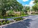 Street view of a well-maintained home in Wilkinson Woods with tropical landscaping and mature trees at 3530 Wilkinson Woods Dr # 14, Sarasota, FL 34231