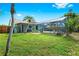 This home's backyard features a screened-in pool and lush vegetation at 3551 65Th Avenue E Cir, Sarasota, FL 34243