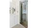 Bright bathroom featuring a large mirror, vanity with storage, and a glass door shower stall at 3551 65Th Avenue E Cir, Sarasota, FL 34243