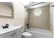 This bathroom features a shower, a sink with a mirror, and a toilet at 3551 65Th Avenue E Cir, Sarasota, FL 34243