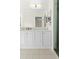 Bathroom featuring a double sink vanity and walk-in shower with glass door at 3551 65Th Avenue E Cir, Sarasota, FL 34243