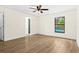 Spacious bedroom with neutral walls, wood-look flooring, and a view of the pool at 3551 65Th Avenue E Cir, Sarasota, FL 34243