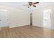 Spacious bedroom with neutral walls and wood-look flooring and ensuite bath and closet at 3551 65Th Avenue E Cir, Sarasota, FL 34243