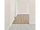 Bright hallway featuring a tile entry that transitions to laminate flooring at 3551 65Th Avenue E Cir, Sarasota, FL 34243