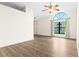 Spacious living room with laminate flooring and a vaulted ceiling with an arched window at 3551 65Th Avenue E Cir, Sarasota, FL 34243