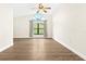Bright living room with a vaulted ceiling, arched window, and laminate flooring at 3551 65Th Avenue E Cir, Sarasota, FL 34243