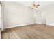 Bright living room featuring laminate flooring and a modern ceiling fan at 3551 65Th Avenue E Cir, Sarasota, FL 34243