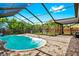 Screened in outdoor pool with a deck that includes a staircase and mature foliage at 3551 65Th Avenue E Cir, Sarasota, FL 34243