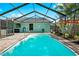 Screened-in pool with brick patio, adjacent seating, and a basketball hoop for outdoor entertainment at 3551 65Th Avenue E Cir, Sarasota, FL 34243