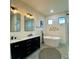 Beautiful bathroom featuring double vanity, soaking tub, modern fixtures, and decorative accents for a luxurious space at 3616 Bellefonte Ave, North Port, FL 34286