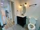 Modern bathroom with a dark vanity, marble countertop, and sleek black fixtures at 3616 Bellefonte Ave, North Port, FL 34286