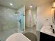 Spacious bathroom featuring a seamless glass shower, soaking tub, and dual sink vanity for ultimate relaxation at 3616 Bellefonte Ave, North Port, FL 34286
